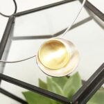 Revolve button pendant in silver and gilt